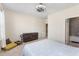 A bedroom with a ceiling fan, dresser, window and adjoining bathroom at 2286 Emerald Sky Dr, Smyrna, GA 30080