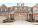 Beautiful townhome with stone and brick facade, two-car garage, and manicured landscaping at 2286 Emerald Sky Dr, Smyrna, GA 30080