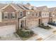 Aerial view showcasing townhome exteriors, attached garages, driveways, and manicured landscaping at 2286 Emerald Sky Dr, Smyrna, GA 30080