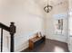 Inviting foyer with dark wood floors, bench seating, decorative light fixture, and white trim at 2286 Emerald Sky Dr, Smyrna, GA 30080