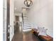Inviting foyer with hardwood floors, a stylish light fixture, staircase, and a comfortable bench at 2286 Emerald Sky Dr, Smyrna, GA 30080