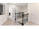 Upstairs hallway with elegant black metal railing and neutral decor at 2286 Emerald Sky Dr, Smyrna, GA 30080