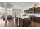 Open-concept kitchen with stainless steel appliances, island seating, and a view of the living area at 2286 Emerald Sky Dr, Smyrna, GA 30080