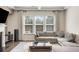 Bright living room with a fireplace, comfortable seating, and ample natural light at 2286 Emerald Sky Dr, Smyrna, GA 30080