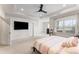 A carpeted Main Bedroom with large windows, a ceiling fan and an adjoining room at 2286 Emerald Sky Dr, Smyrna, GA 30080
