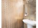 Elegant powder room with designer wallpaper and a decorative mirror at 2286 Emerald Sky Dr, Smyrna, GA 30080