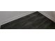 A close up of dark gray vinyl floors with white baseboards in a corner of a room at 2533 Piering Dr, Lithonia, GA 30038