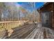 Outdoor deck with wooden flooring, railing, and a private backyard surrounded by mature trees at 277 Hope Dr, Dallas, GA 30157