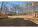 Large backyard with mature trees, wooden fencing, and a shed at the back of the property at 277 Hope Dr, Dallas, GA 30157