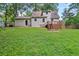 Sprawling backyard with a wood deck, mature trees, and a lush lawn at 277 Hope Dr, Dallas, GA 30157