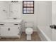 Bathroom featuring tile floor, toilet, tub, vanity, and window at 277 Hope Dr, Dallas, GA 30157