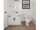 Cozy bathroom features white fixtures, vanity, toilet, and tub-shower combination with tile flooring at 277 Hope Dr, Dallas, GA 30157