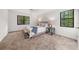 Airy bedroom features two bright windows, neutral colors, and soft, carpeted floors at 277 Hope Dr, Dallas, GA 30157