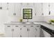 Bright kitchen features white cabinets, marble countertops, and stainless steel sink at 277 Hope Dr, Dallas, GA 30157