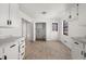 Open-concept kitchen features tile floors, white cabinets, granite countertops, and a breakfast area at 277 Hope Dr, Dallas, GA 30157