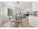 Eat-in kitchen featuring stainless appliances, white cabinets and chairs surrounding a glass table at 277 Hope Dr, Dallas, GA 30157