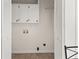 Laundry room features a utility sink, overhead cabinets, and washer/dryer hookups at 277 Hope Dr, Dallas, GA 30157