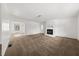 Spacious living room with neutral carpet and a white fireplace, offering a cozy atmosphere at 277 Hope Dr, Dallas, GA 30157