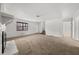 Expansive living room featuring a fireplace, neutral carpet, and an entrance to the upper level at 277 Hope Dr, Dallas, GA 30157