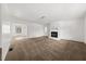 Spacious living room featuring neutral carpet, a fireplace, and white walls for a bright and airy feel at 277 Hope Dr, Dallas, GA 30157