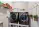 Laundry room with front load washer and dryer, shelving, and decor at 4038 Laura Jean Way, Buford, GA 30518