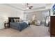 Spacious main bedroom with tray ceiling, accent wall, plush carpet, and sitting area at 4038 Laura Jean Way, Buford, GA 30518