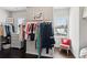 Bright walk-in closet with custom shelving, rods, dark wood floor, and natural light from window at 4038 Laura Jean Way, Buford, GA 30518