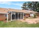 Backyard featuring brick facade, patio, and well-maintained lawn at 256 Olde Oaks Ln, Riverdale, GA 30274