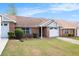 Charming brick home with a well-maintained lawn, attached garage, and inviting entrance at 256 Olde Oaks Ln, Riverdale, GA 30274