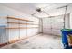 A spacious garage features ample shelving and a bright, natural light source at 256 Olde Oaks Ln, Riverdale, GA 30274