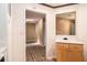 Hallway with wood-look floors and skylight leading to a cabineted counter space at 256 Olde Oaks Ln, Riverdale, GA 30274