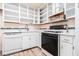 Functional kitchen with white cabinetry, laminate countertops, and gas range at 256 Olde Oaks Ln, Riverdale, GA 30274