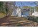 Backyard with a mix of grass, trees and a fence for privacy, with steps up to the back of the home at 3608 Stedman Pl, Duluth, GA 30096