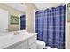 Bathroom features a white vanity, new faucet, mirror, and a shower-tub combination with a decorative curtain at 3608 Stedman Pl, Duluth, GA 30096