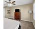 Bedroom featuring wood dresser, soft carpet, a floor lamp, a ceiling fan, and natural light through the window at 3608 Stedman Pl, Duluth, GA 30096