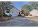 Charming home exterior with attached garages, set amongst a backdrop of lush trees at 3608 Stedman Pl, Duluth, GA 30096