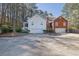 Inviting two-story home with attached garages and circular driveway nestled amongst mature trees at 3608 Stedman Pl, Duluth, GA 30096