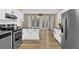 Bright kitchen features stainless steel appliances, granite countertops, wood floors, and a sunlit breakfast nook at 3608 Stedman Pl, Duluth, GA 30096
