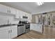 Bright kitchen with white cabinets, granite countertops, and modern stainless steel appliances at 3608 Stedman Pl, Duluth, GA 30096
