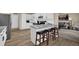 Modern kitchen with white cabinets, granite countertops, and seamless access to the living room at 3608 Stedman Pl, Duluth, GA 30096