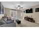 Comfortable living room with a ceiling fan, ample seating, and views through the French doors at 3608 Stedman Pl, Duluth, GA 30096