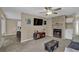 Inviting living area with a fireplace, tv, and seamless access to kitchen and sunroom at 3608 Stedman Pl, Duluth, GA 30096