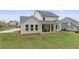 Backyard featuring a covered patio and a lush green lawn with neighborhood views at 4060 Andover Cir, Mcdonough, GA 30252