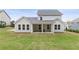 Backyard featuring a covered patio, green lawn, and views of the neighborhood at 4060 Andover Cir, Mcdonough, GA 30252