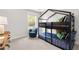 bedroom featuring a bunk bed, chair, plush carpet, and large window at 4060 Andover Cir, Mcdonough, GA 30252