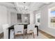 Bright dining room with modern chandelier, coffered ceiling and large windows at 4060 Andover Cir, Mcdonough, GA 30252