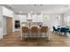 Bright kitchen with white cabinets, an island with bar stool seating, and wood-look floors at 4060 Andover Cir, Mcdonough, GA 30252
