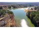 Scenic aerial view of a tranquil lake surrounded by lush greenery and mature trees at 770 Huiet Dr, Mcdonough, GA 30252