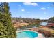 Stunning aerial view of a pool overlooking a lake with boat docks at 770 Huiet Dr, Mcdonough, GA 30252