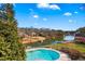 Stunning aerial view of a pool overlooking a lake with boat docks at 770 Huiet Dr, Mcdonough, GA 30252